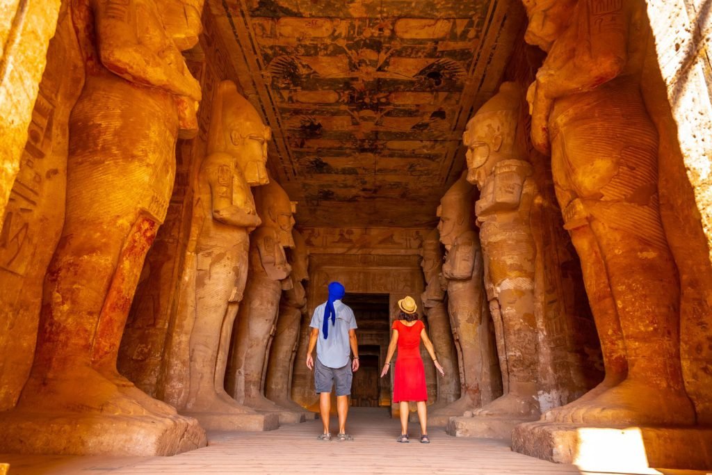 Travelers in the pillared hall inside the Great Temple of Abu Simbel