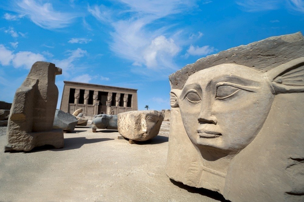 A carved stone head of the goddess Hathor in the Dendera temple grounds