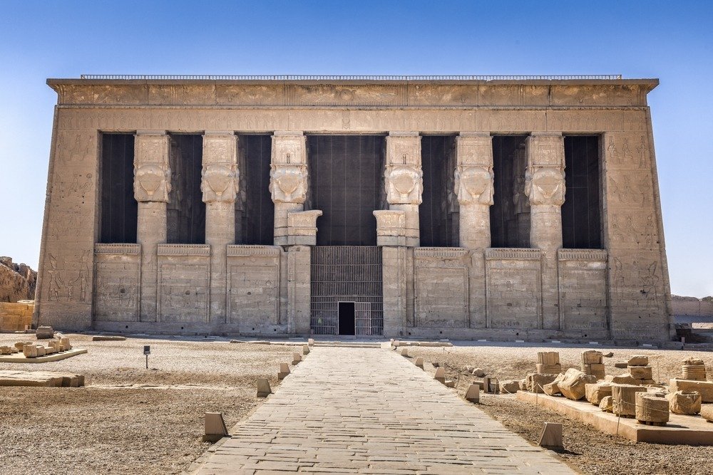 The columned front of the Temple of Hathor at Dendera at the end of a stone path