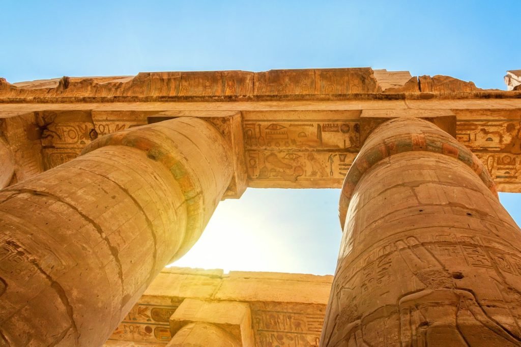 Looking up between the giant carved columns of Karnak's Hypostyle Hall