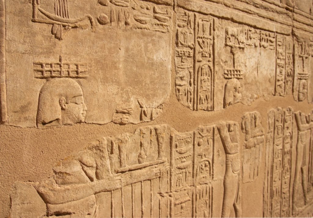 Karnak Temple history in stone: carved reliefs and hieroglyphs on a temple wall