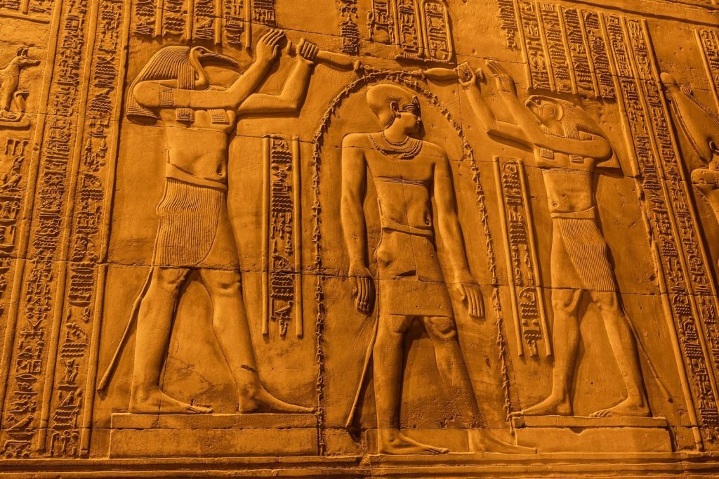 Carved reliefs of gods on a wall at Kom Ombo Temple