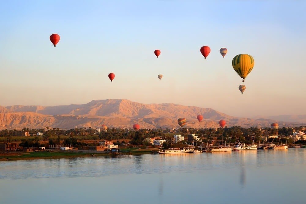 Hot-air balloons in the morning sky above the Nile at Luxor