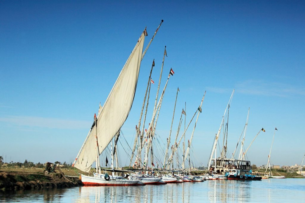 Feluccas with tall masts moored on the Nile at Luxor