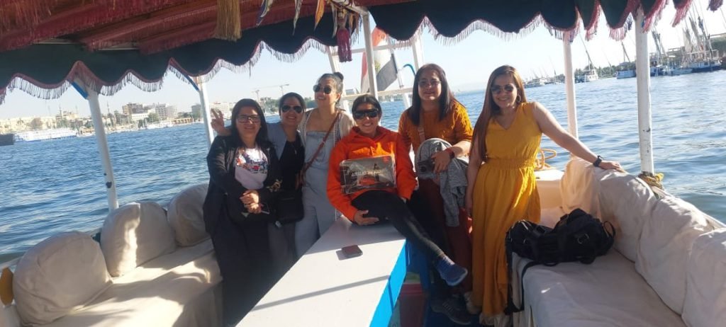 A group of travelers sitting on a felucca on the Nile