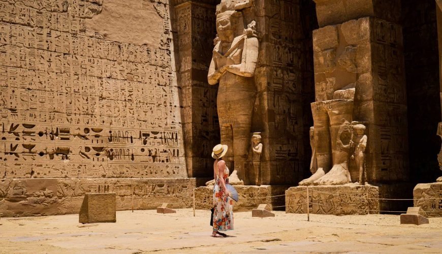 A traveler in the carved court of Medinet Habu