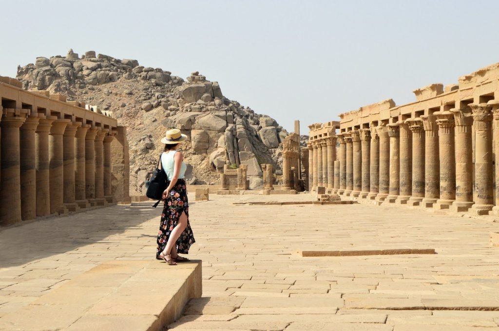 A traveler in the colonnaded forecourt of the Temple of Philae