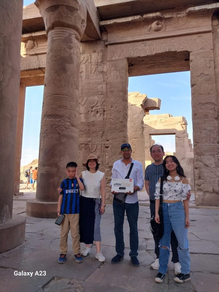A family of travelers among the columns of the Temple of Philae