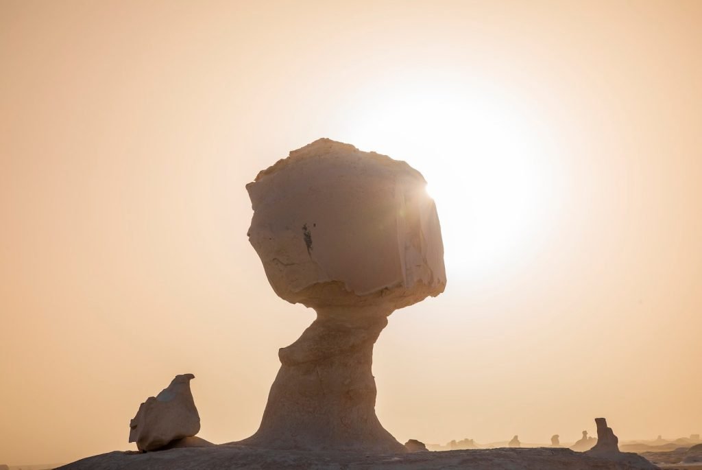 The mushroom-shaped chalk rock of the White Desert against the setting sun