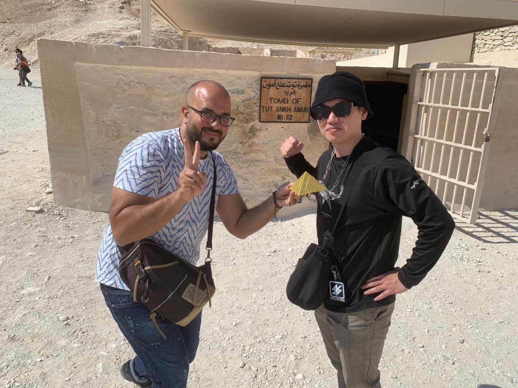 An Amwaj Tour guide and a traveler posing at the entrance to the tomb of Tutankhamun in the Valley of the Kings