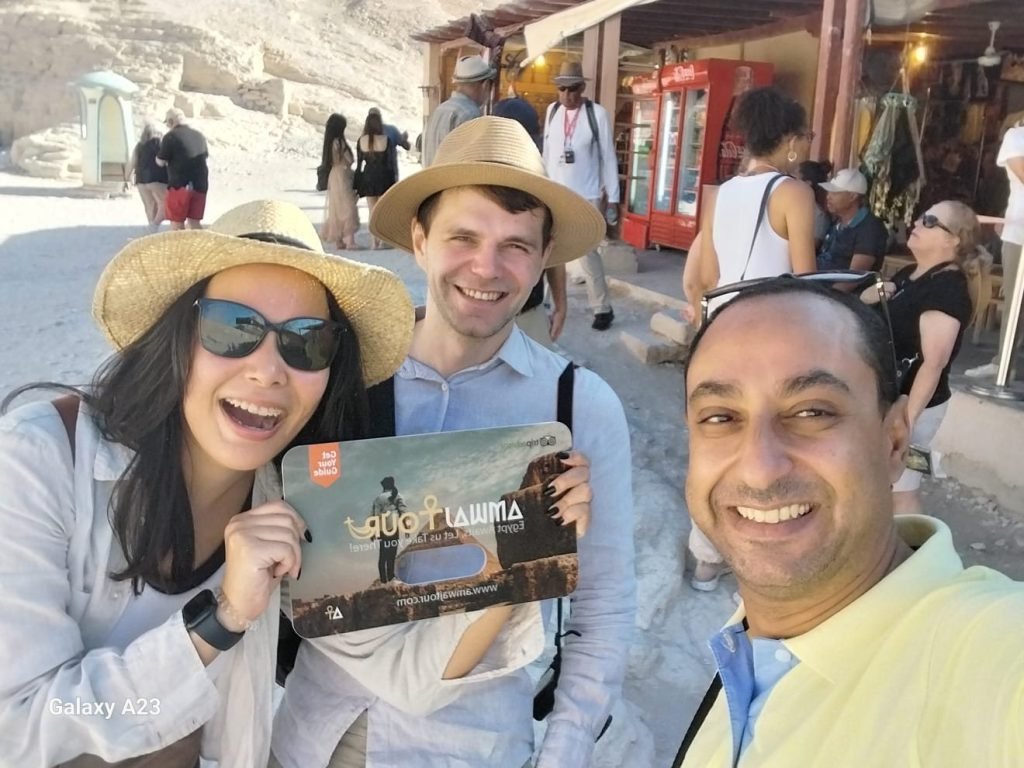 An Amwaj Tour guide taking a selfie with two laughing travelers in the Valley of the Kings